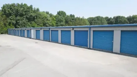 Line of drive-up outdoor storage units with metal roll-up doors
