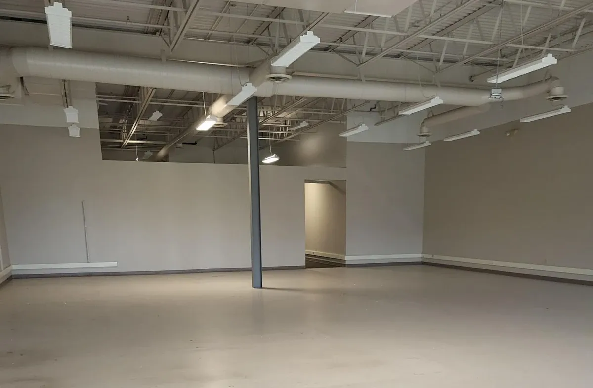 empty office space with exposed ceiling and air ducts