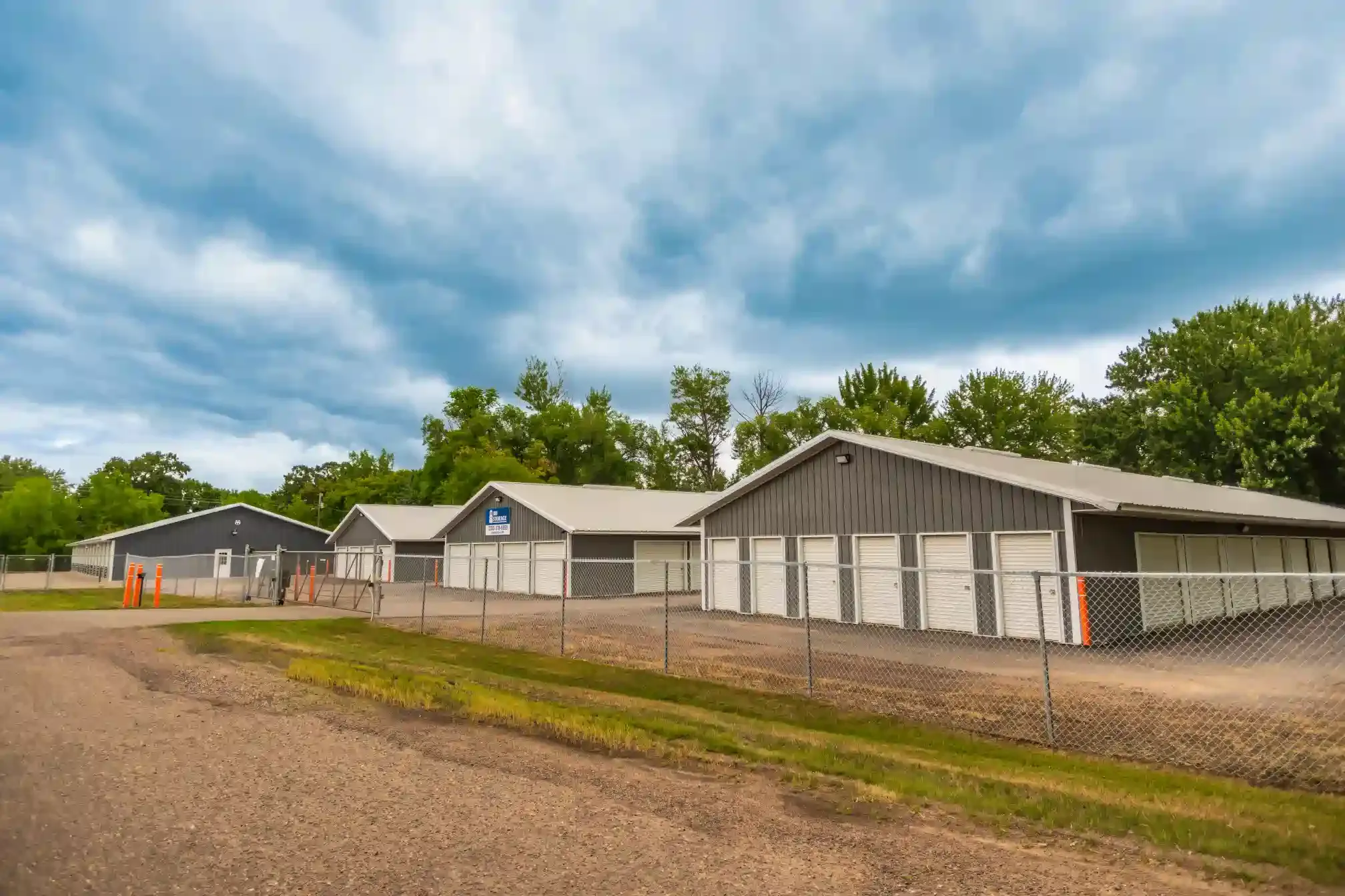 Three unit buildings and a fence.