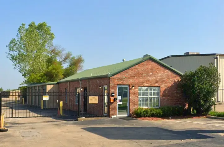 Exterior of a brick office with a gate along one wall