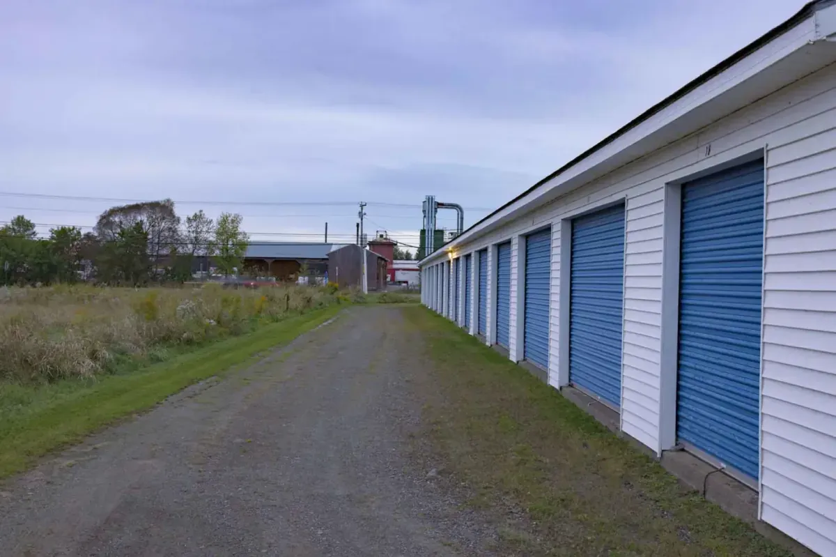 A row of storage units at the edge of the property.