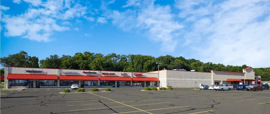 image of a strip mall with mostly empty parking lot